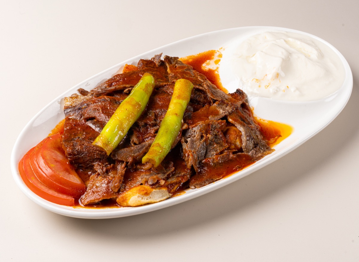 Iskender kebab, sliced beef döner with tomato sauce, grilled peppers and yogurt