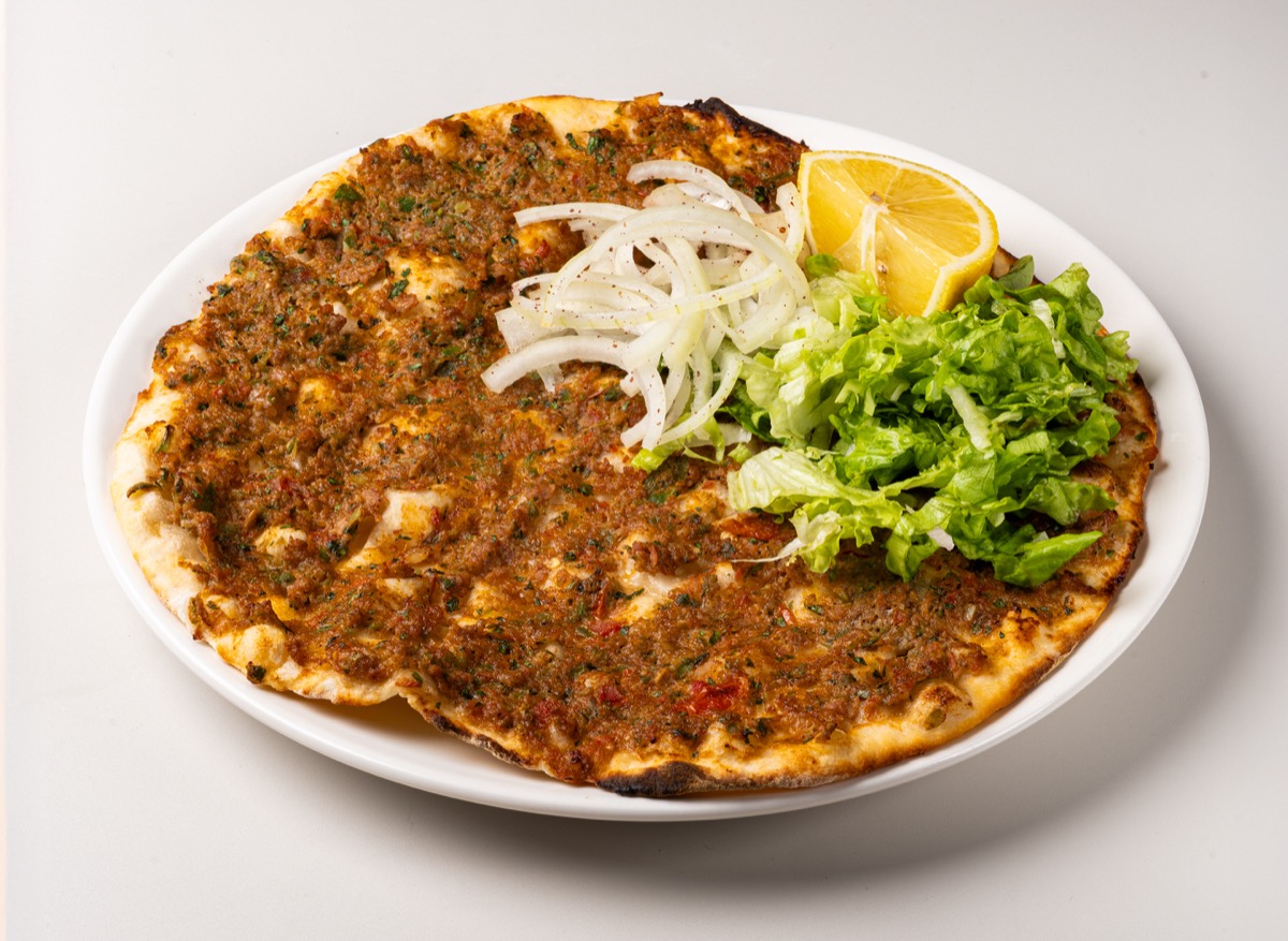 Lahmacun, thin crust Turkish pizza topped with spiced minced beef