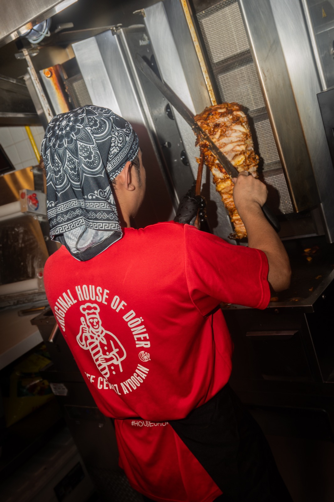Chef Cengiz Aydogan carving fresh döner from the vertical spit at House of Döner
